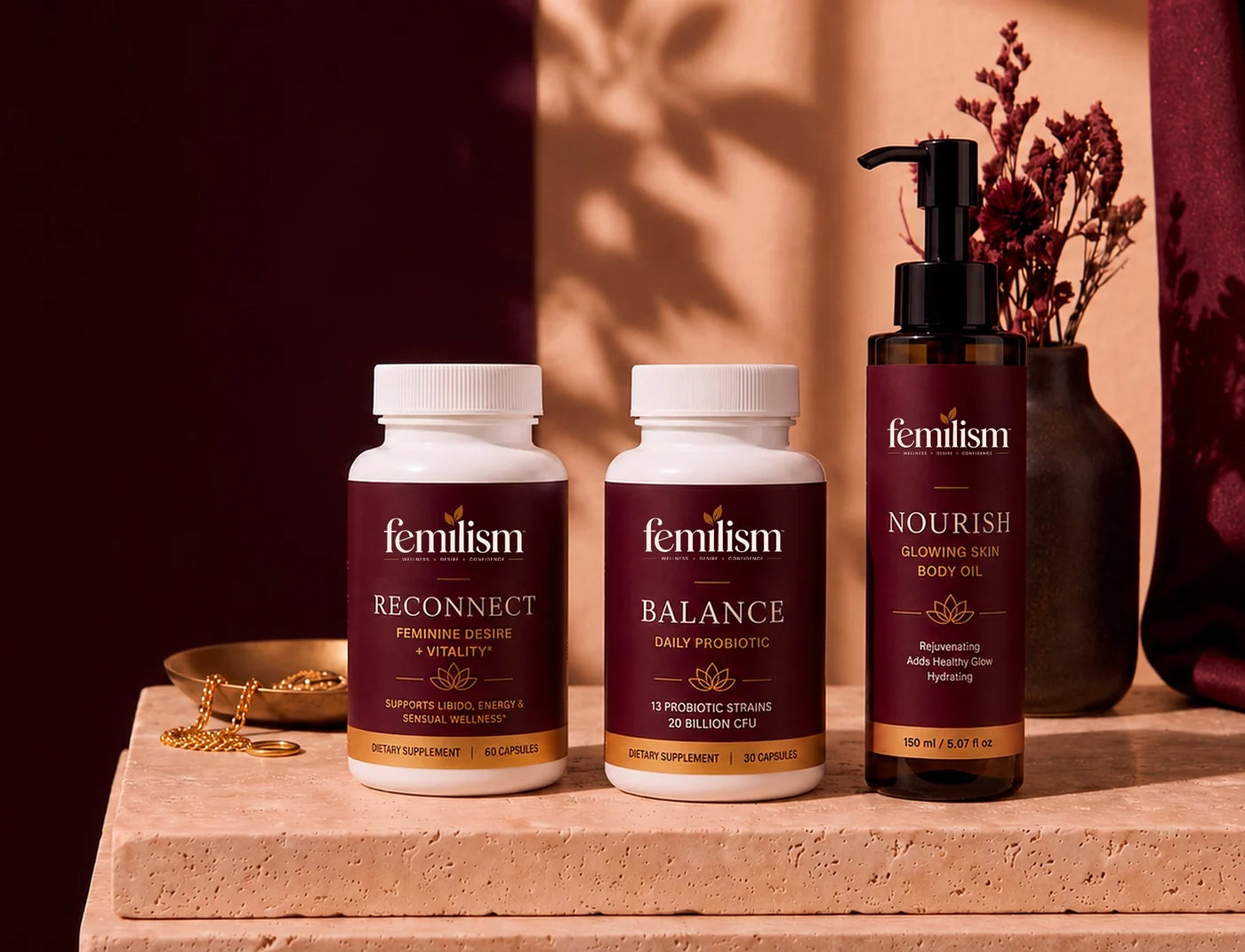 The femilism range — Reconnect, Balance and Nourish — on a travertine slab